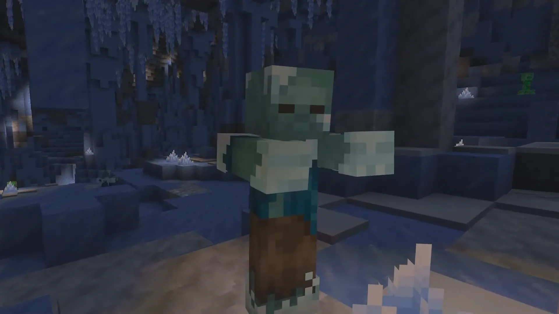 Frozen Zombie v ledové jeskyni s ledovými krystaly a creeperem v pozadí