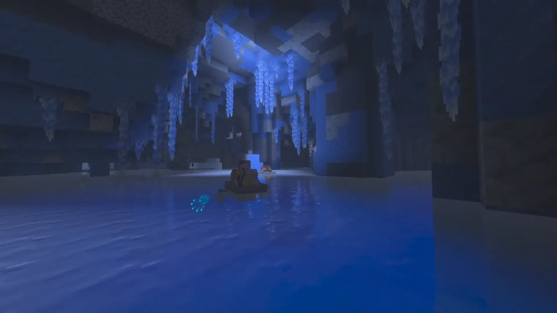 Loďka v zaplavených Ice Caves se zářícími ledovými krystaly a glow squid