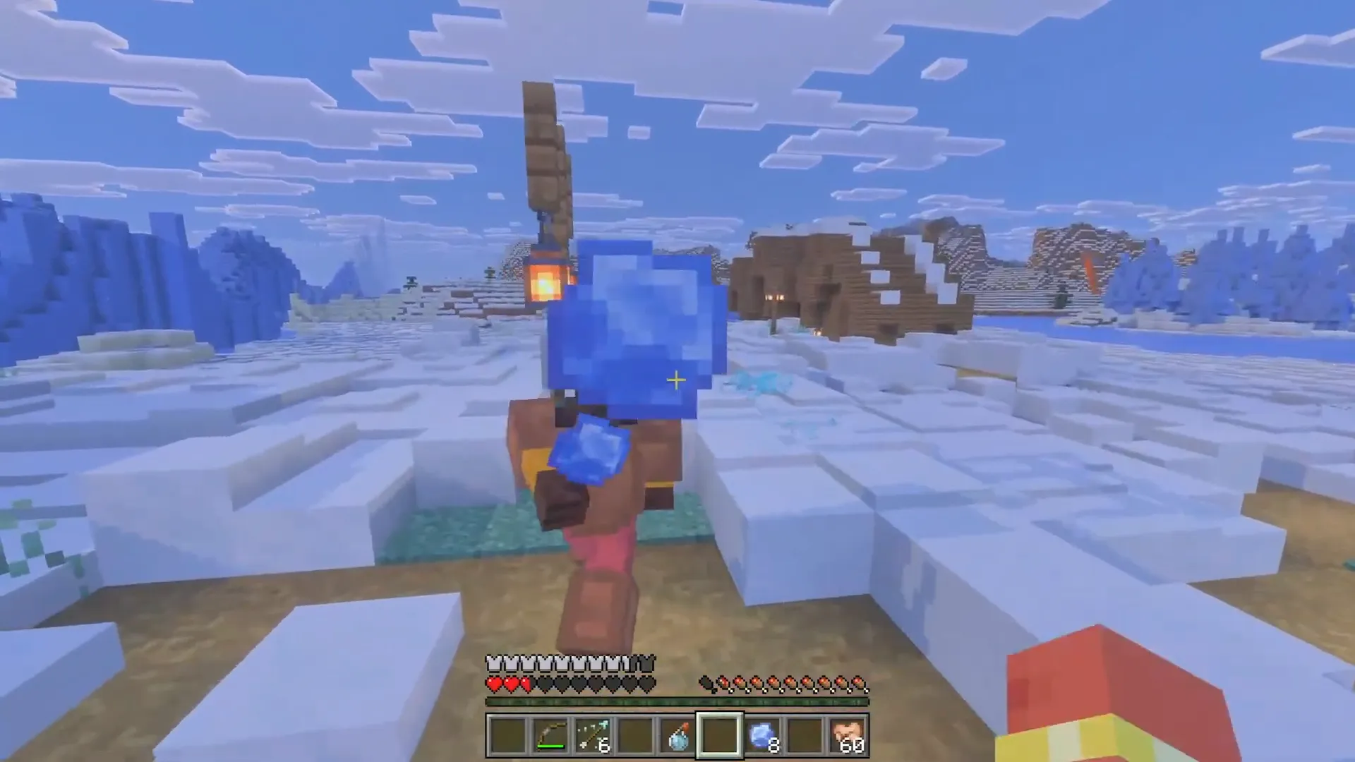 Hráč hází ledovou kouli se zmrazovacím efektem v zasněženém biomu Minecraft